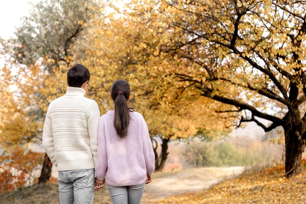 Couple in love in the autumn leaves