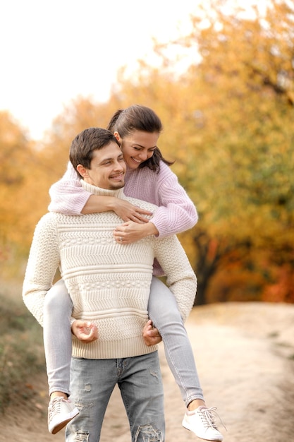 Couple in love in the autumn leaves