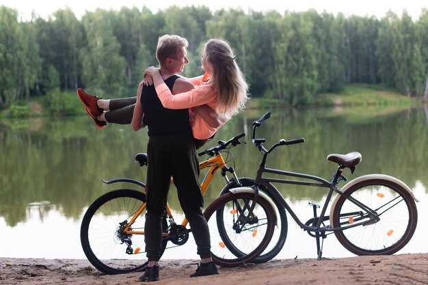 Photo the couple in love on bikes in the woods in the park