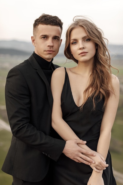 Photo couple in love in black dress and suit