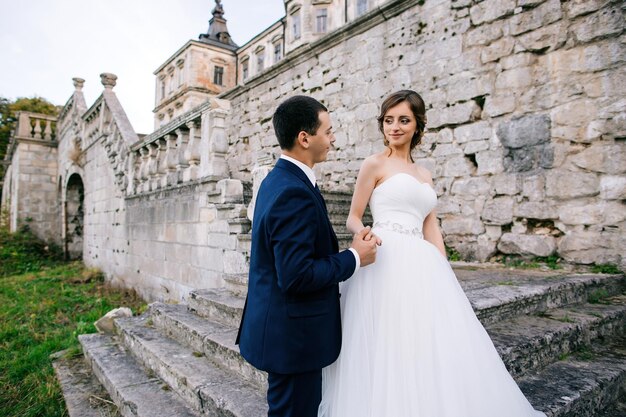 Couple in love Bride and groom kissing on stairs of old palace