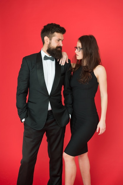 Couple in love on date. business meeting fashion. formal fashion look. Proposal or engagement party. Formal couple of man in tuxedo and sexy woman. Bearded tuxedo man and woman. Always in style.