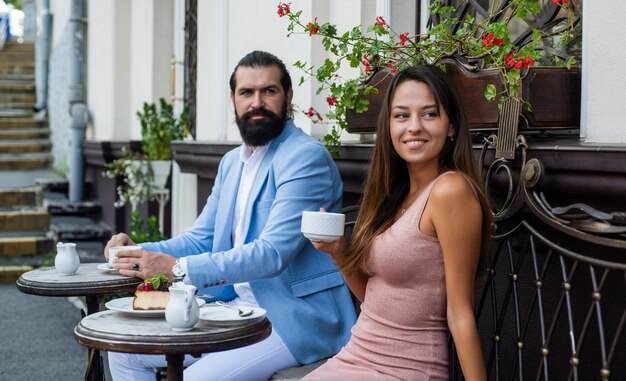 Couple in love drink morning coffee in cafe outdoor on romantic date, love meet.