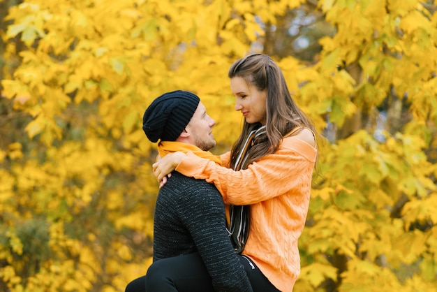 恋するカップルが秋の森で抱き合う