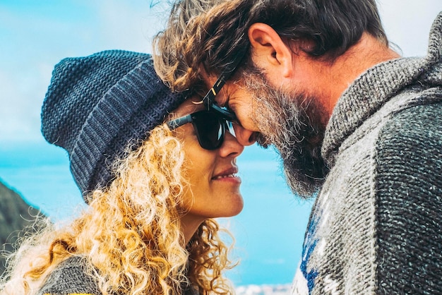 Couple in love enjoy outdoor leisure activity together with sweetness concept of life together forever and dating winter warm clothes and ocean coastline view for travel tourist man and woman