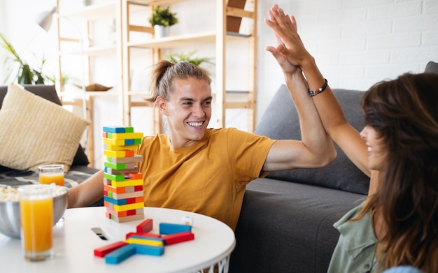 Couple in love enjoying their time together and having fun while playing board game