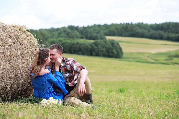 Couple in love in a field at sunset