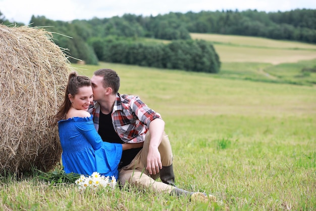 Couple in love in a field at sunset