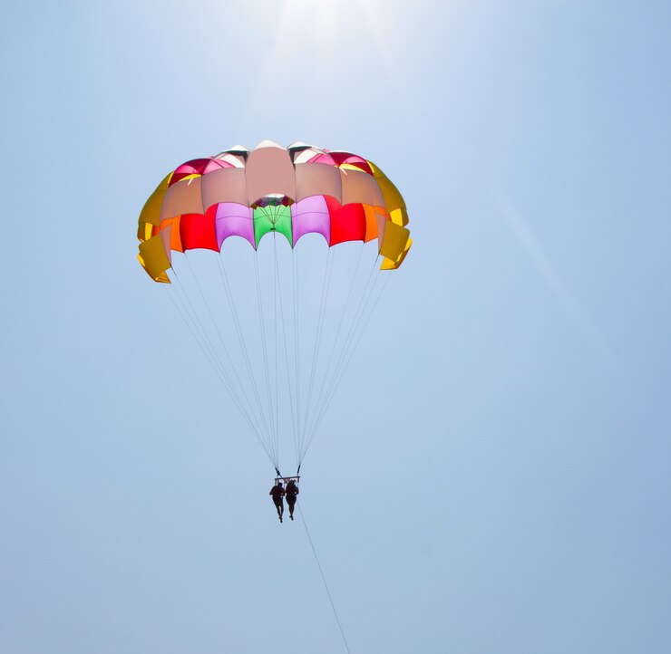 A couple in love fly across the sky on a parachute behind a yacht. A family that loves risky entertainment. Sea holidays in southern countries