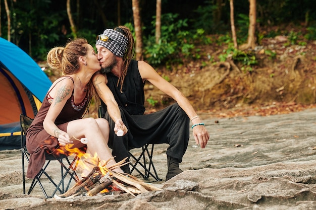 Couple in love frying marshmallows