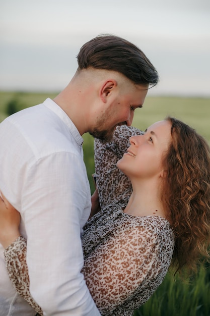 Couple in love on green field of wheat