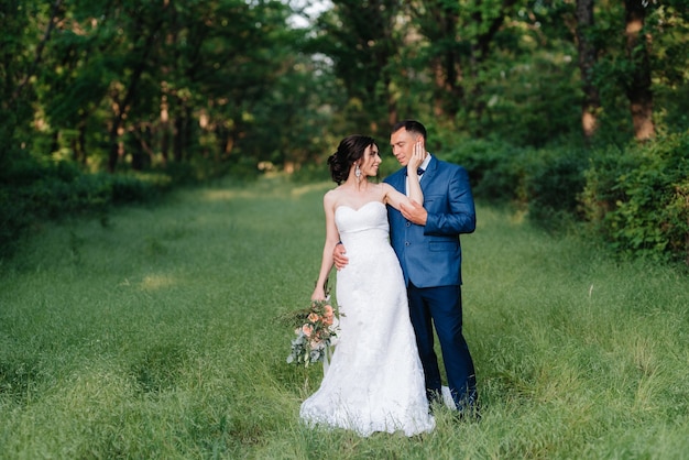 A couple in love a guy and a girl on a walk in the forest belt