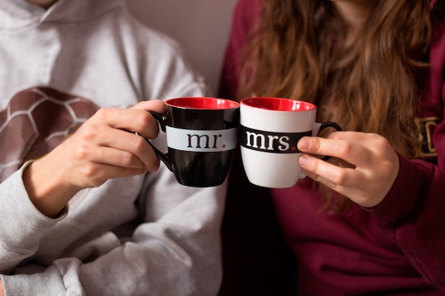 Couple in love hands with cups