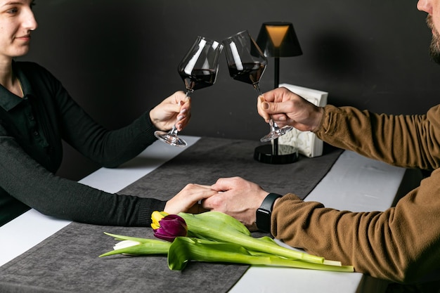 a couple in love holding hands in a restaurant