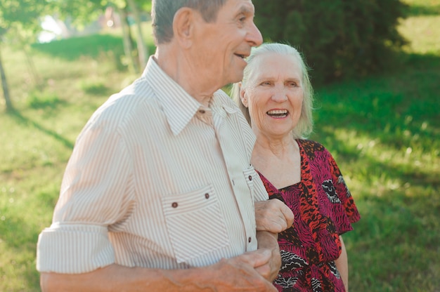 Couple in love holding hands on a walk in the park in summer.