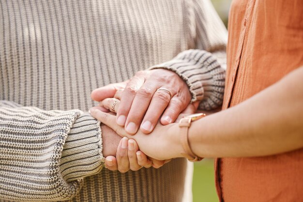 Photo couple love and holding hands with trust hope or support for bad news cancer or death comfort closeup zoom empathy and people together for understanding compassion or kindness security or care