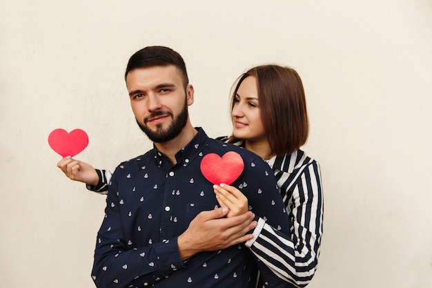 Couple in love holding red hearts