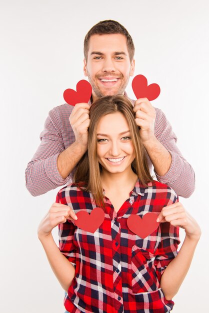 Couple in love holding red paper hearts