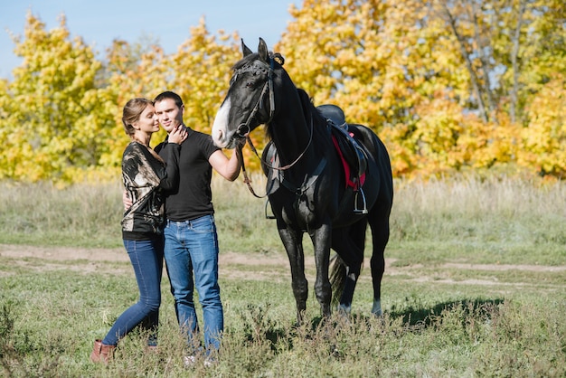 Couple in love horseback riding