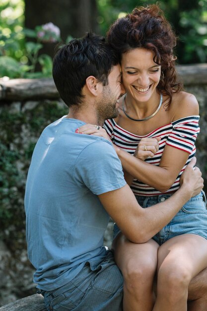 Couple in love hugging on bench in a park