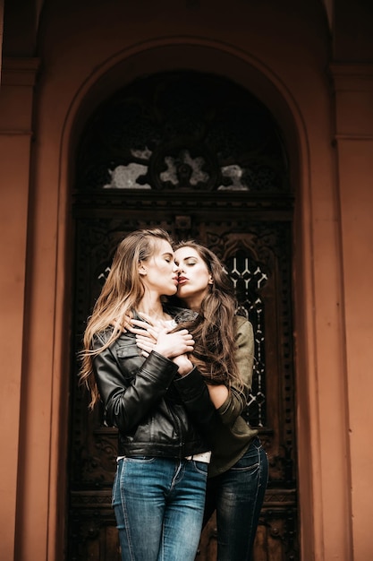 Couple in love hugging and kissing in jeans outdoors