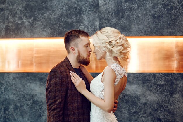 Couple in love hugs and kisses on their wedding day.