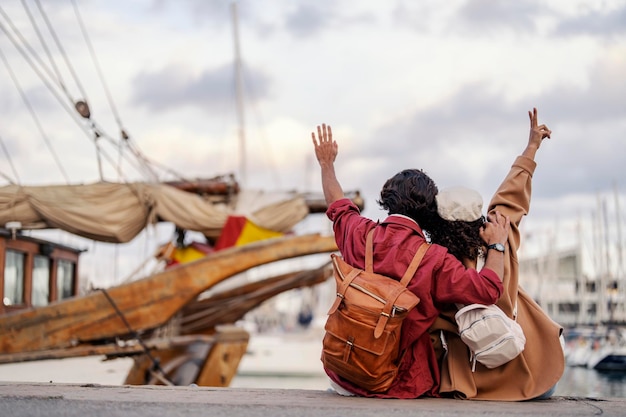 A couple in love is hugging and enjoying the view on a dock during their trip to Europe