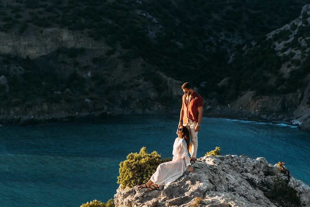 Couple in love on an island off the coast.  Young couple by the sea. Man and woman travel to beautiful places. Couple in love at the lagoon. Honeymoon trip. Relax on the island. Wedding travel