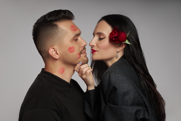 Couple in love kissing lipstick marks on their face a kiss Rose flowers love hugs Man and woman husband and wife
