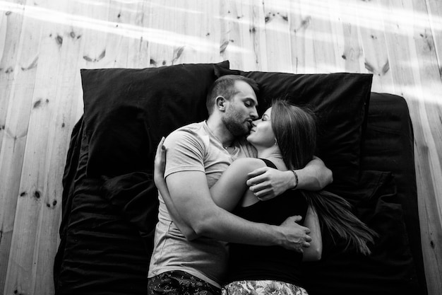 A couple in love kissing on a mattress