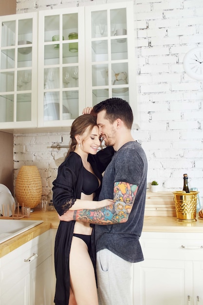 Couple in love in the kitchen in the morning hugs and prepares Breakfast.