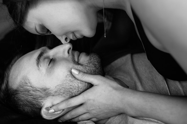 A couple in love lying on a bed cuddling