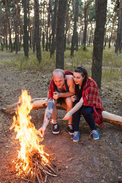 Couple love nature picnic bonfire forest concept.