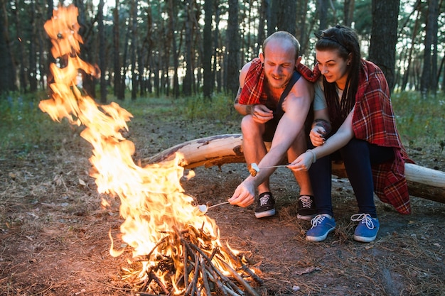 Couple love nature picnic bonfire forest concept.