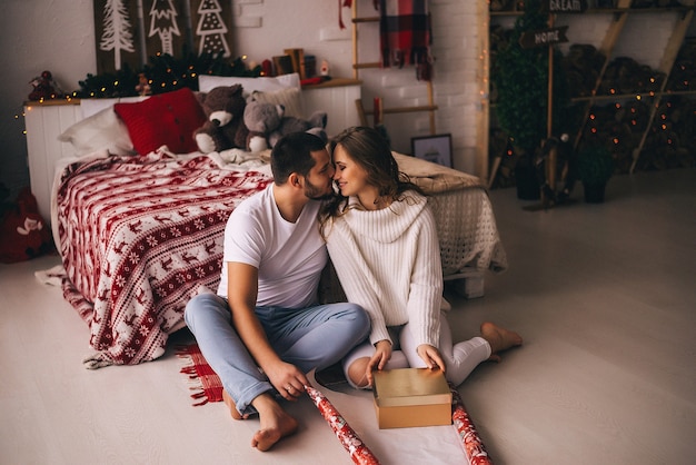 Couple in love packing christmas gifts. Newyear