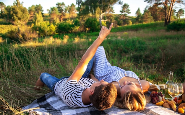 Couple in love on a picnic in the park. Nature. Selective focus