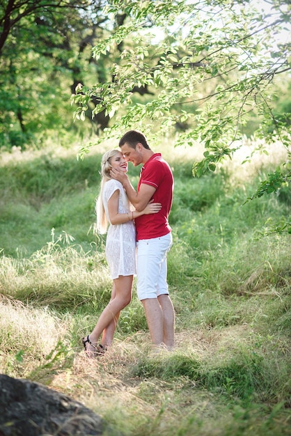 Couple in love at a picnic in a park with green grass