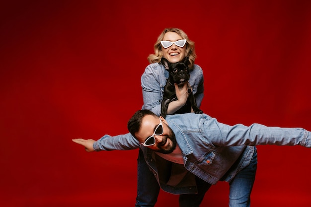 Couple in love posing fun with french bulldog happy couple portrait with dog