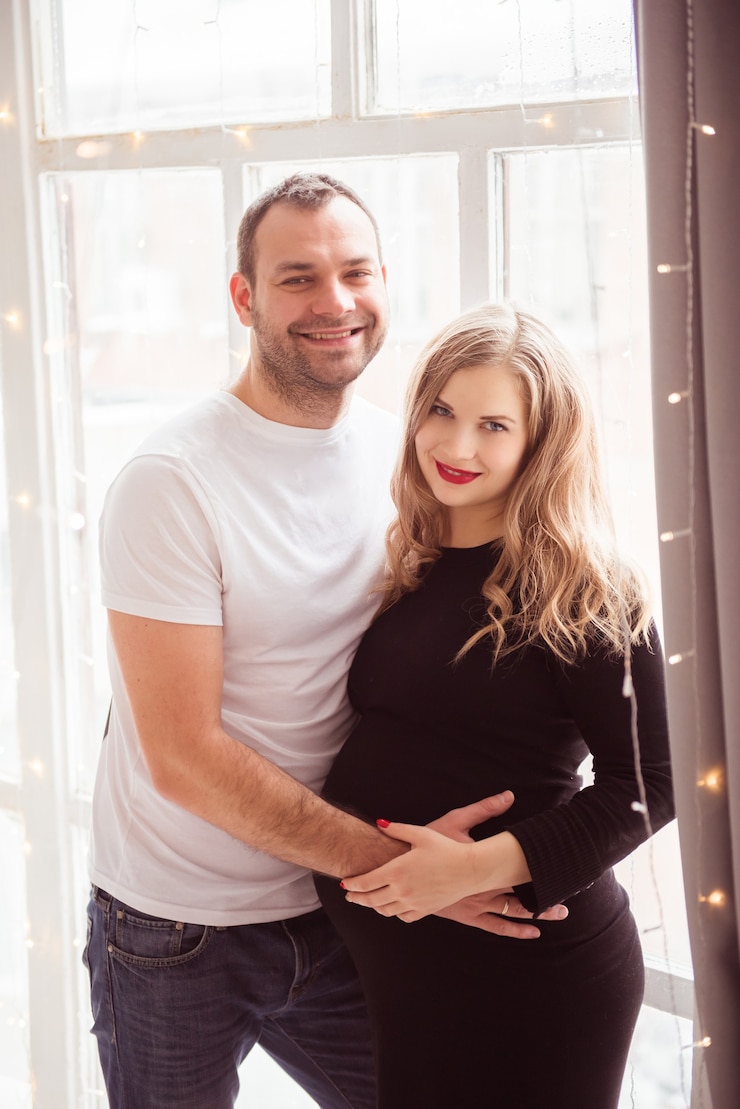 Photo couple in love pregnant cuddling, waiting for baby