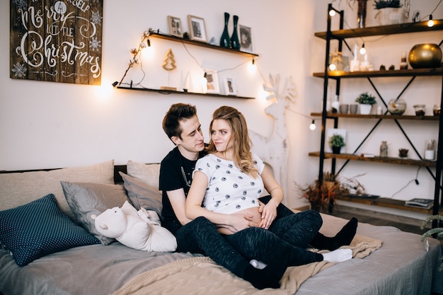 Couple in love pregnant cuddling, waiting for baby
