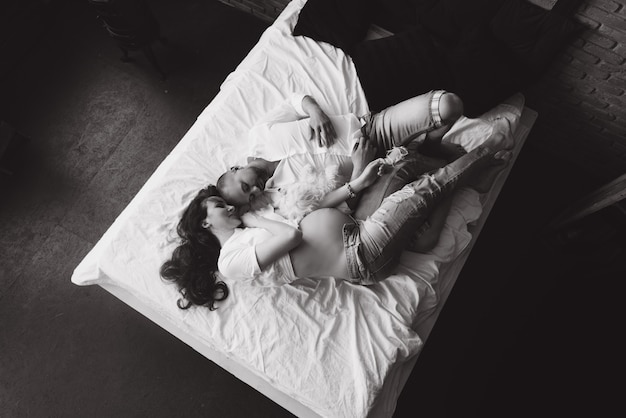 Photo couple in love pregnant lie in bed cuddling, waiting for baby