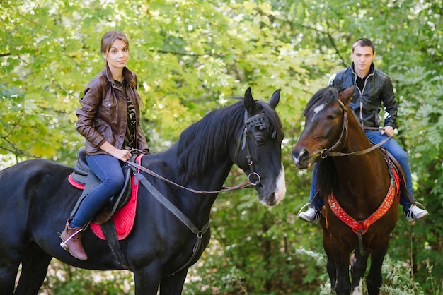 Couple in love riding horses