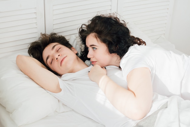 Couple in love sleeps cuddling in bed