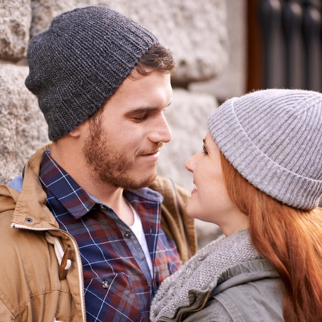 couple love and smile with closeup in outdoor at sidewalk or against in cold weather together and support in london relationship date and bonding for romance with soulmate care and happiness