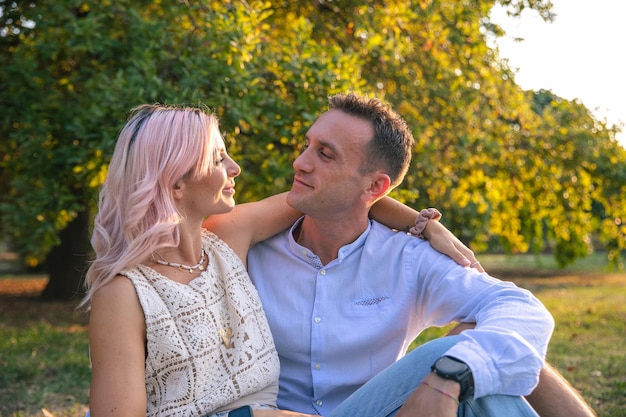 Couple in love spend time together at a public park during sunset