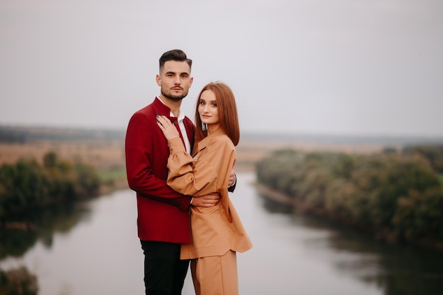 A couple in love standing on the river bank.