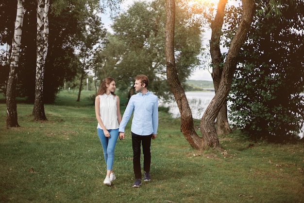 Couple in love standing walking along the shore of the lake