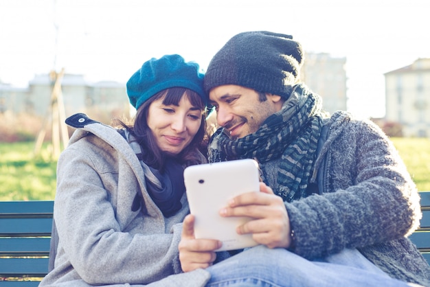 Photo couple in love using tablet at the park