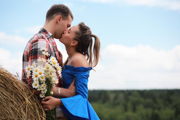 couple in love in a village field at sunset