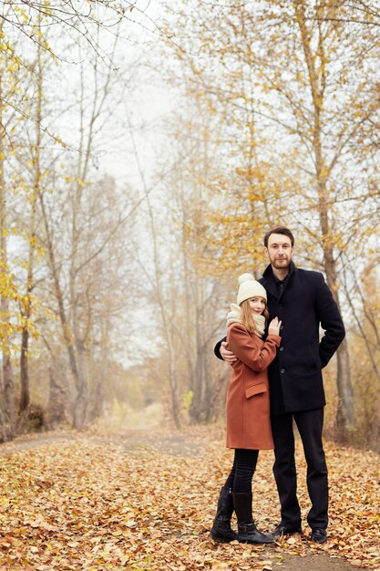 Couple in love walking in the autumn Park, cool fall weather.